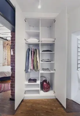 a walk in closet with white shelves at Doctors Spacious Place in Istanbul