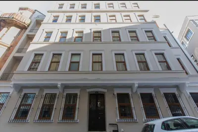 a large white building with a black door at Doctors Spacious Place in Istanbul
