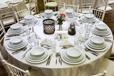 a white table with white plates and silverware on it at Royal Hotel Inegol in Inegol