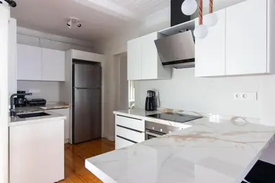 a kitchen with white cabinets and a white counter top at Historic 2BR Gem in Downtown Sisli AC in All Rooms in Istanbul