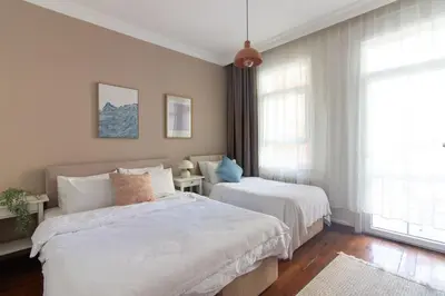 a bedroom with two beds and a window at Tasteful & Spacious 3BR Haven in Trendy Şişli in Istanbul