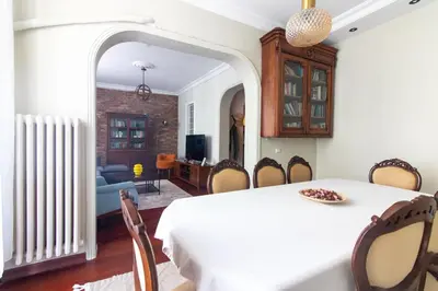 a dining room with a white table and chairs at Tasteful & Spacious 3BR Haven in Trendy Şişli in Istanbul