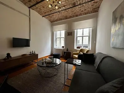 a living room with a couch and a table at Historical Flat in Galata - Tatar Beyi Street - TRA 2026 Award-Winner in Istanbul