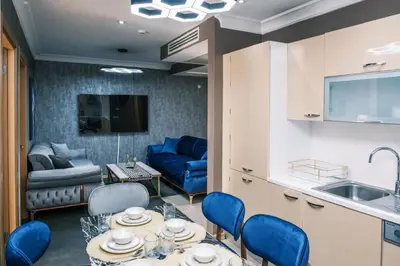a kitchen and living room with a table and chairs at MELVİN HOMe in Istanbul
