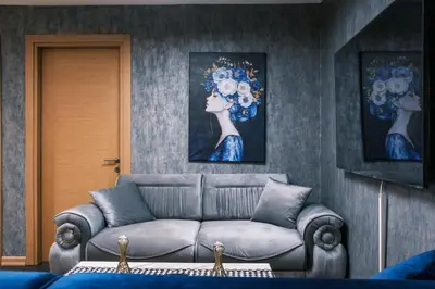 a living room with a couch and two paintings at MELVİN HOMe in Istanbul