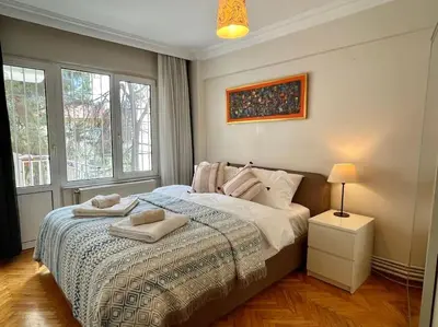 a bedroom with a bed with two towels on it at Bright Cozy Stacked Home Ideally Located n Kadikoy in Istanbul