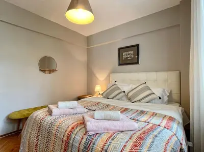a bedroom with a large bed with two pillows on it at Bright Cozy Stacked Home Ideally Located n Kadikoy in Istanbul