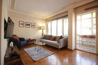 a living room with a couch and a table at Bright Cozy Stacked Home Ideally Located n Kadikoy in Istanbul