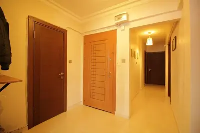 an empty hallway with a wooden door and a hallway at Bright Cozy Stacked Home Ideally Located n Kadikoy in Istanbul