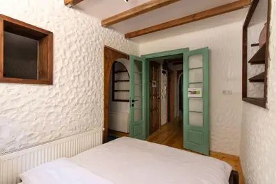 a bedroom with a bed and a green door at Authentic 1BR w Private Patio in Hype Cihangir in Istanbul