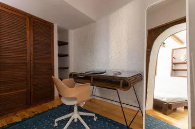 a room with a desk and a chair and a bed at Authentic 1BR w Private Patio in Hype Cihangir in Istanbul