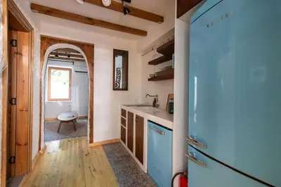 a kitchen with a sink and a refrigerator at Authentic 1BR w Private Patio in Hype Cihangir in Istanbul