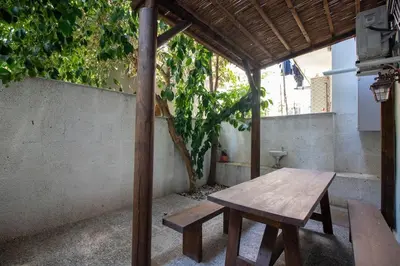 a wooden picnic table sitting under a pavilion on a patio at Authentic 1BR w Private Patio in Hype Cihangir in Istanbul