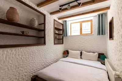a bedroom with a bed and a window and shelves at Authentic 1BR w Private Patio in Hype Cihangir in Istanbul
