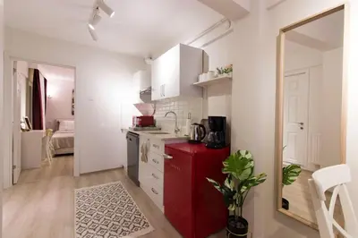 a kitchen with a red refrigerator in a room at Fully Renovated 2BR Flat in Prime Location at Moda in Istanbul