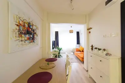 a kitchen and living room with a table and a couch at Fully Renovated 2BR Flat in Prime Location at Moda in Istanbul