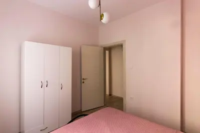 a bedroom with a pink bed and a closet at Soft modern inspiring flat in the center of Moda in Istanbul