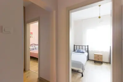 a room with a bedroom with a bed and a mirror at Soft modern inspiring flat in the center of Moda in Istanbul
