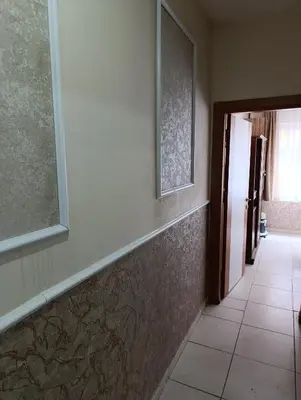 a hallway with a wall with two pictures on it at Merkez İstanbul in Istanbul