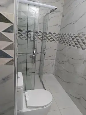 a bathroom with a toilet and a shower at Merkez İstanbul in Istanbul