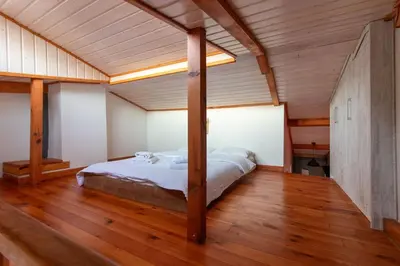 a bedroom with a bed in a room with wooden floors at Kuzguncuk Retreat W Stunning Views and Local Charm in Istanbul