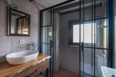 a bathroom with a sink and a glass shower at Kuzguncuk Retreat W Stunning Views and Local Charm in Istanbul