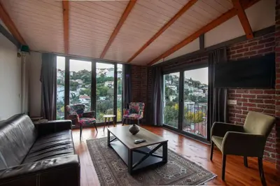 a living room with a couch and a table andwindows at Kuzguncuk Retreat W Stunning Views and Local Charm in Istanbul