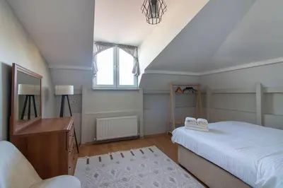 a bedroom with a bed and a desk and a window at Charming 2BR Panoramic Views Penthouse in Maltepe in Istanbul