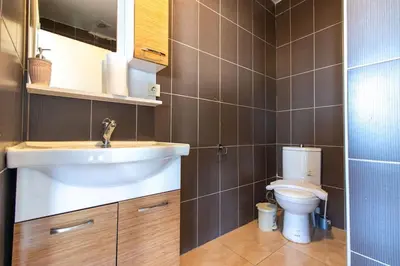 a bathroom with a sink and a toilet at Charming 2BR Panoramic Views Penthouse in Maltepe in Istanbul