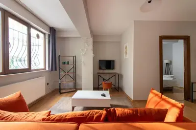 a living room with a couch and a table at Cozy Modern 1BR w Patio New Building in Maltepe in Istanbul