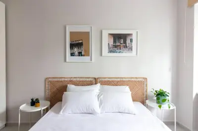 a bedroom with a white bed with two tables at 2BR Flat W Modern Touches in Adalar