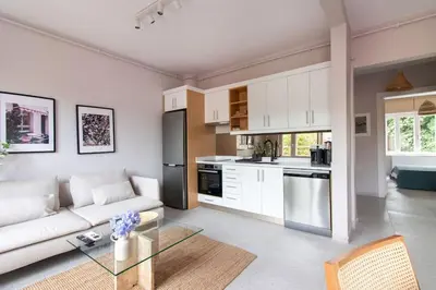 a living room with a white couch and a kitchen at 2BR House W Island Charm in Adalar