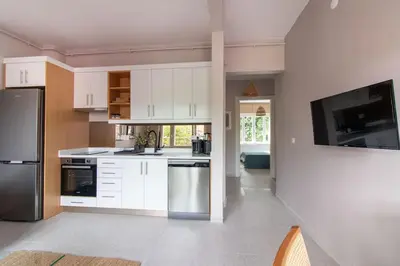 a kitchen with white cabinets and stainless steel appliances at 2BR House W Island Charm in Adalar