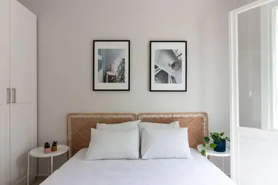 a bedroom with a bed with three pictures on the wall at 2BR House W Island Charm in Adalar