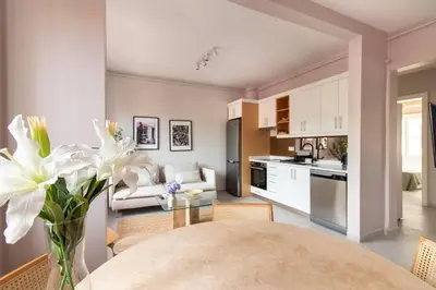 a kitchen and living room with a table and flowers at 2BR House W Island Charm in Adalar