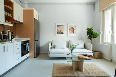 a living room with a couch and a table at Designed and Modern 2BR Flat In Center Of Buyukada in Adalar
