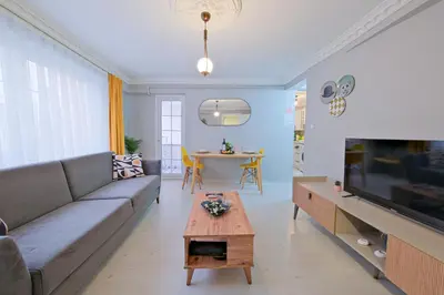 a living room with a couch and a table at Taksim İstiklalin Kalbinde Konforlu Daire Netflix Wifi in Istanbul