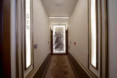 a hallway with two windows and a long corridor at Grand Hotel de Pera in Istanbul