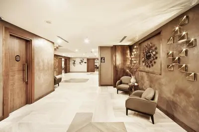 a corridor of a hotel lobby with chairs at Grand Hotel de Pera in Istanbul
