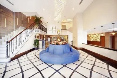 a large lobby with a blue couch in the middle of it at Grand Hotel de Pera in Istanbul