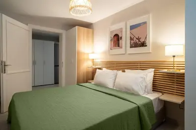 a bedroom with a bed with a green blanket at 2BR Designed Flat In The Center of Buyukada in Adalar
