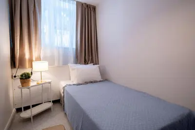 a small bedroom with a bed and a window at 2BR Designed Flat In The Center of Buyukada in Adalar