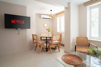 a living room with a table and chairs at Modern and Designed 2BR W Garden in Adalar
