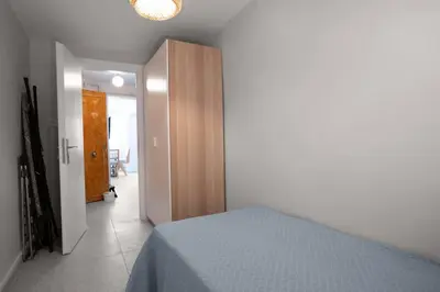 a bedroom with a bed and a wooden closet at Modern and Designed 2BR W Garden in Adalar