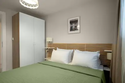 a bedroom with a green bed and white pillows at Modern and Designed 2BR W Garden in Adalar