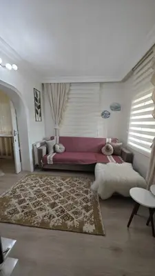 a living room with a large couch and a rug at A beautiful house on the Bosphorus in a wonderful garden in Istanbul