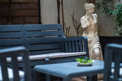 a statue of a woman standing next to a bench at Spacious and Stylish 3BR w Private Garden in Istanbul