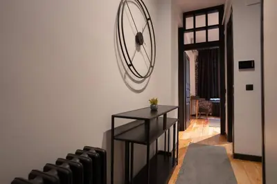 a room with a black table and some chairs at Spacious and Stylish 3BR w Private Garden in Istanbul