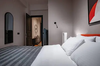 a bedroom with a large white bed and a hallway at Spacious and Stylish 3BR w Private Garden in Istanbul