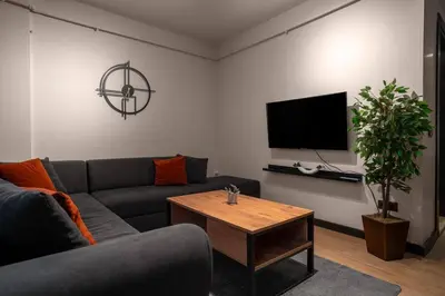 a living room with a couch and a table at Spacious and Stylish 3BR w Private Garden in Istanbul